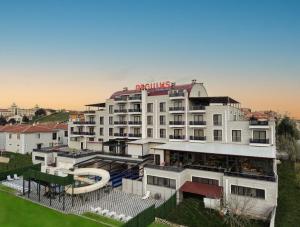 a large white building with a pool and a resort at Afyon Regulus Thermal Apart Hotel & Villas in Gazligol