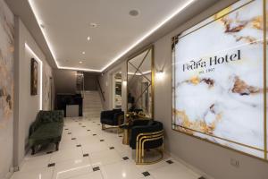 a hallway with a salon with chairs and a large window at FEDRA HOTEL in Paralia Katerinis