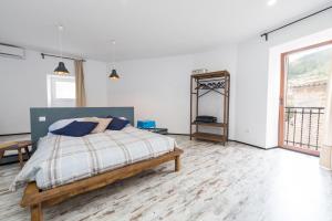 a white bedroom with a bed and a mirror at Darrera Es Campanar in Bunyola