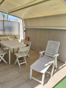 a table and chairs on a porch with a table and chairs at Willys House Barletta in Barletta