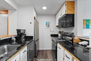 a kitchen with a sink and a refrigerator at Decatur #1797 in Keystone +24 photos
