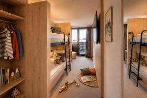 a childs bedroom with bunk beds and a hallway at Victoria Hotel & Residence in Villars-sur-Ollon