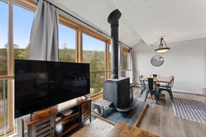 a living room with a flat screen tv and a fireplace at Decatur #1797 in Keystone