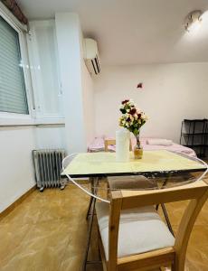 a dining room table with a vase of flowers on it at MK VALeNCIA in Valencia