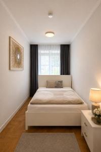 a bedroom with a large bed with a window at Stendaler Apartments in Stendal