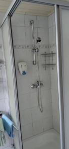 a shower in a bathroom with a glass door at Pension Brunner in Bad Kleinkirchheim +35 photos