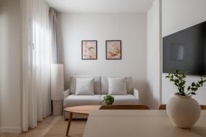 a living room with a couch and a table at Líbere Seville Triana in Seville