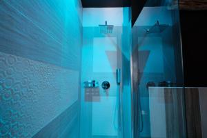 a bathroom with a shower with a glass door at RADICI DI LUNA Exclusive Design in Castelsardo +78 photos
