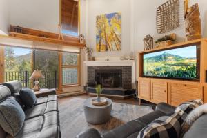 a living room with a couch and a television at Pines #2041 : 2 in Keystone