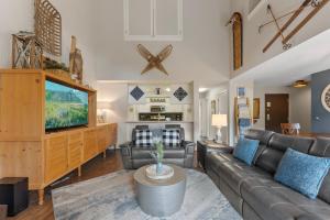 a living room with a couch and a flat screen tv at Pines #2041 : 2 in Keystone