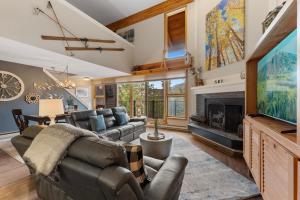 a living room with a couch and a tv and a fireplace at Pines #2041 : 2 in Keystone
