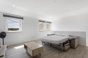 a white room with a bed and a table at Casa "O Chafariz" in Amoreira +12 photos