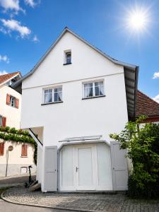 a white house with a garage at Casa Anno 1782 in Markdorf