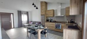 a kitchen with a table with wine glasses on it at Lar do Cacheiro in Meaño