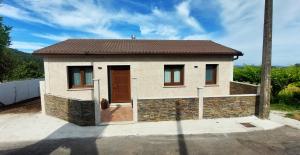 a small house with a brown door at Lar do Cacheiro in Meaño