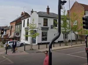 a street with a traffic light and a white building at Entire 1 Bed Central Flat - St Albans in St. Albans