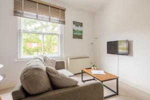 a living room with a couch and a table at Entire 1 Bed Central Flat - St Albans in St. Albans