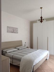 a bedroom with a bed and a chandelier at La casa di Pina in Latronico