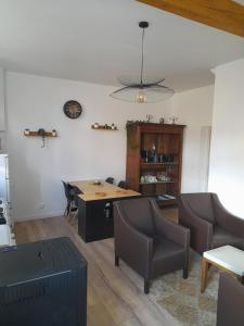 a living room with a table and chairs at Gîte aux 3 Cep in Magnien