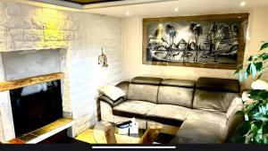 a living room with a couch and a fireplace at Ferienwohnung Meise in Sundern