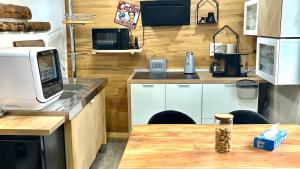 a kitchen with a table with a microwave and a counter top at Ferienwohnung Meise in Sundern
