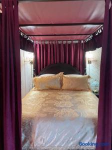 a purple canopy bed with two pillows on it at Hillcrest Bed and Breakfast in Jim Thorpe