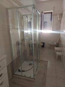 a glass shower in a bathroom with a toilet at Mare Blu' in Crotone