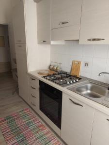 a kitchen with a stove and a sink at Mare Blu' in Crotone