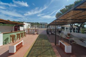 a patio with tables and chairs on a building at Hotel Cadaqués1962 by Fimedhotels in Cadaqués