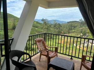 a balcony with chairs and a view of a mountain at Annfield Cabana in Hatton