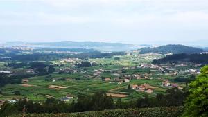 a view of a small town in a green field at Lar do Cacheiro in Meaño