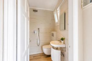 a bathroom with a toilet and a sink at Nikos Villas - Poolside Getaways in Kavos, Corfu in Kavos