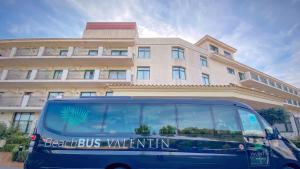 a blue bus parked in front of a building at Valentin Son Bou in Son Bou