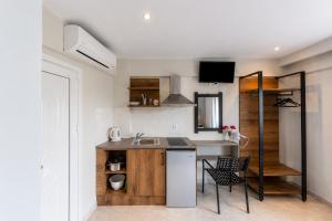 a kitchen with a sink and a counter top at Nikos Villas - Poolside Getaways in Kavos, Corfu in Kavos