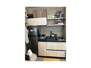 a small kitchen with a sink and a refrigerator at Qerret Boutique Studio Apartment in Golem