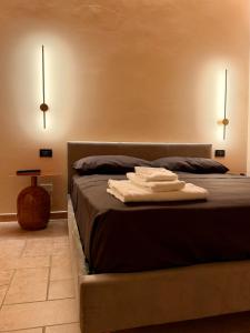 a bedroom with a bed with two towels on it at Villa Iulia - VIBRA in Controguerra +47 photos