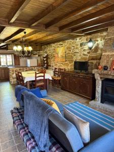 a living room with a couch and a table at Casa do Campo in Montalegre