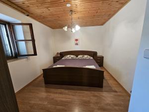 a bedroom with a bed and a wooden ceiling at Villa Caroiba in Karojba +42 photos