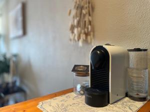 a toaster sitting on top of a wooden table at TERRASSE Vue MARINA - PARKING Privé - Port Commerces & PLAGE à PIED - Vue Exceptionnelle - RétroMirabeau "Côté Mer" in Gruissan