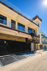a apartment building with a balcony and a staircase at Sukoon stays Bhimtal 3 bed in Bhīm Tāl