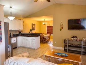 a kitchen and living room with a couch and a table at Near Cavendish Beach-1 in Stanley Bridge