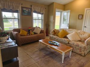a living room with a couch and a coffee table at Near Cavendish Beach-1 in Stanley Bridge