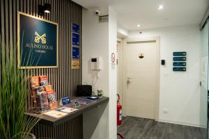an office with a desk and a sign on a wall at Aulino House in Catania
