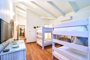 a room with two bunk beds and a desk at Las Margaritas, Casa de Campo in La Romana +9 photos