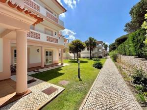 a house with a walkway in front of a yard at Casa Lesarlo - T3 luxury, garden, pool - Praia D'El Rey in Casal da Lagoa Seca