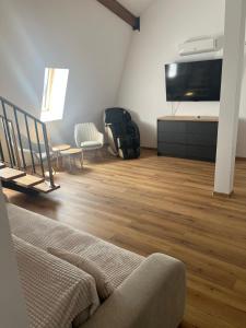 a living room with a couch and a flat screen tv at Central View Penthouse & Parking in Târgu-Mureş