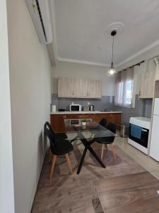 a kitchen with a table and chairs in a room at Center Twin Apartments - 2 in Chios