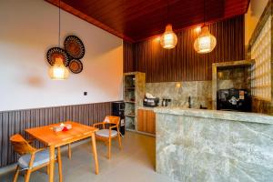 a dining room with a wooden table and chairs at Puri Arta Villa in Ubud