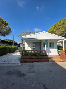 a small white house with a porch and a driveway at Camping San Javier in San Javier