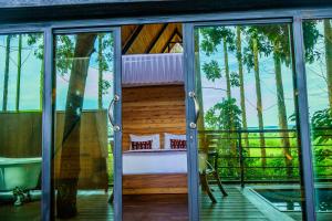 a room with a view of the balcony of a house at Wild geese Lodge in Lulongo